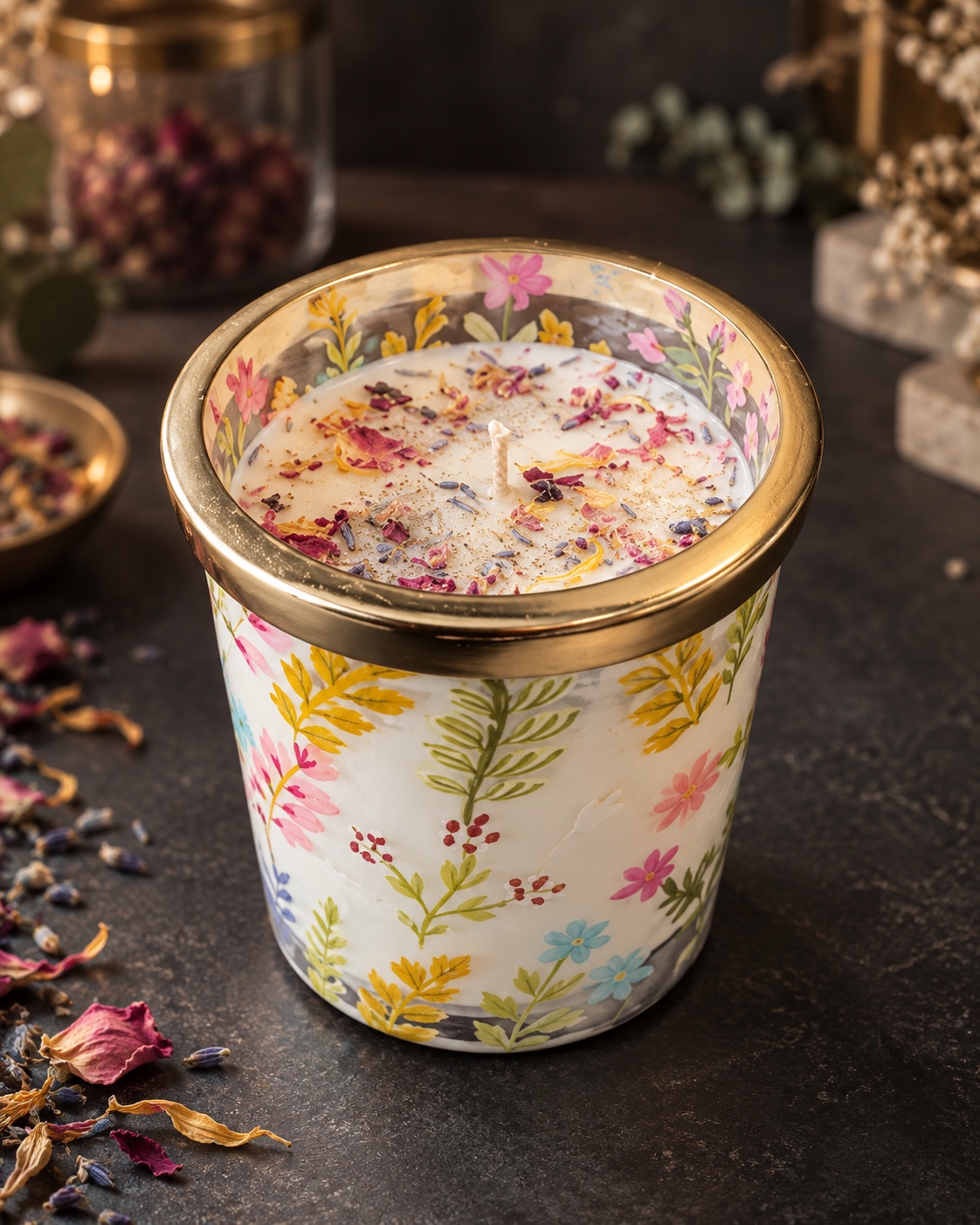 A finished floral candle decorated with dried petals