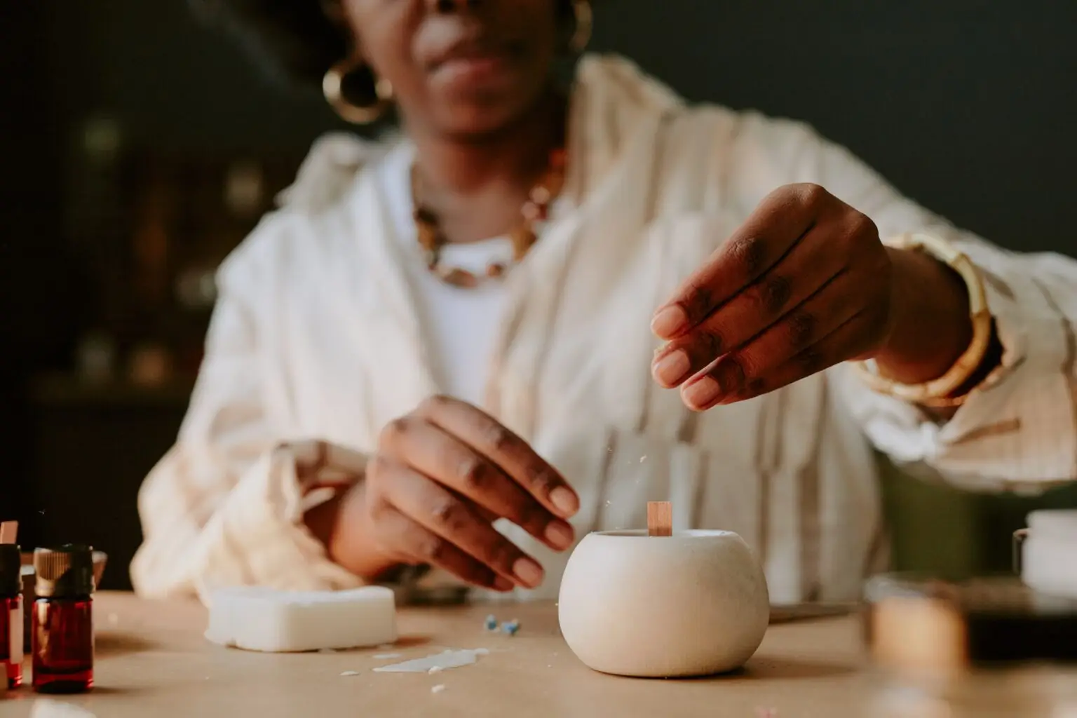 Preparing a candle at the studio worktable
