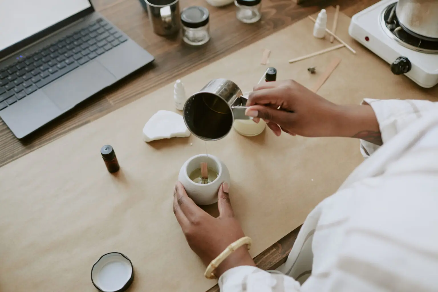 Pouring wax into a candle vessel